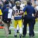 Michigan head coach Brady Hoke walks with junior quarterback Denard Robinson on the field as they wait out the results of a questionable play during the fourth quarter at Iowa on Saturday. Melanie Maxwell I AnnArbor.com